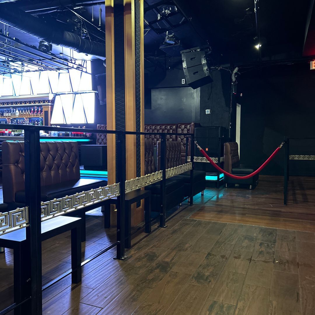A bar with a red rope between the tables