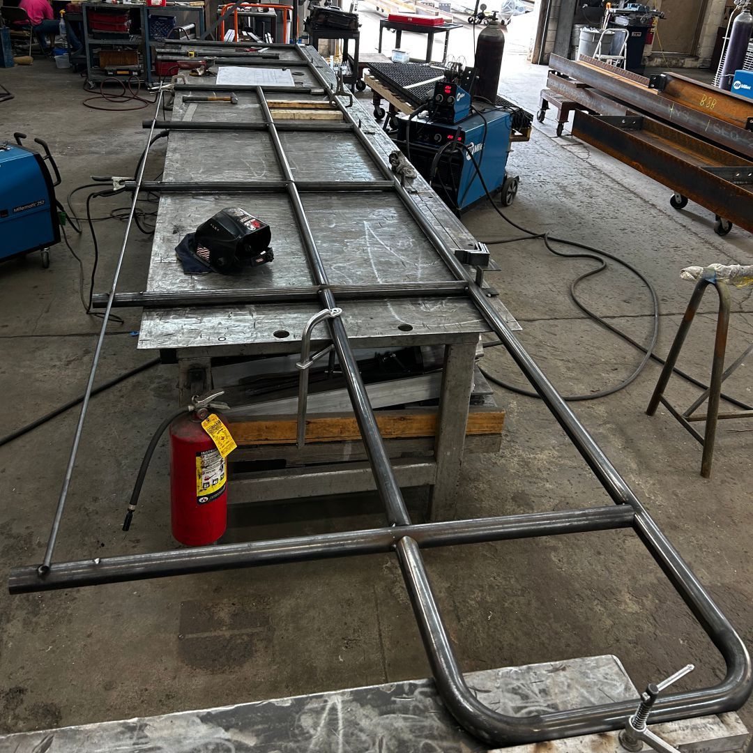 A fire extinguisher is sitting on a table in a workshop