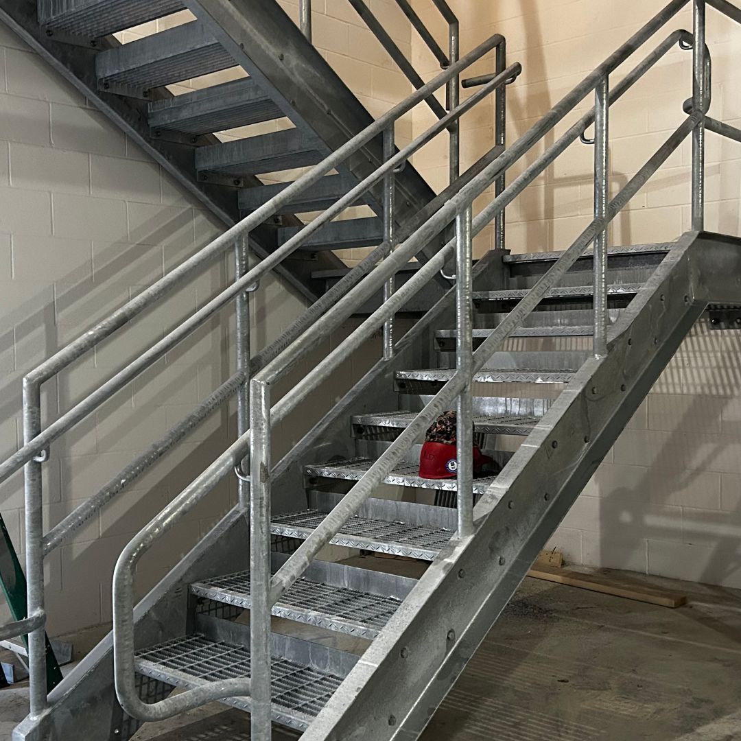A metal staircase with a metal railing in a building.