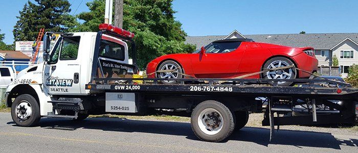 Lock Out Services — Modern Red Car on Tow Truck in Seattle, WA