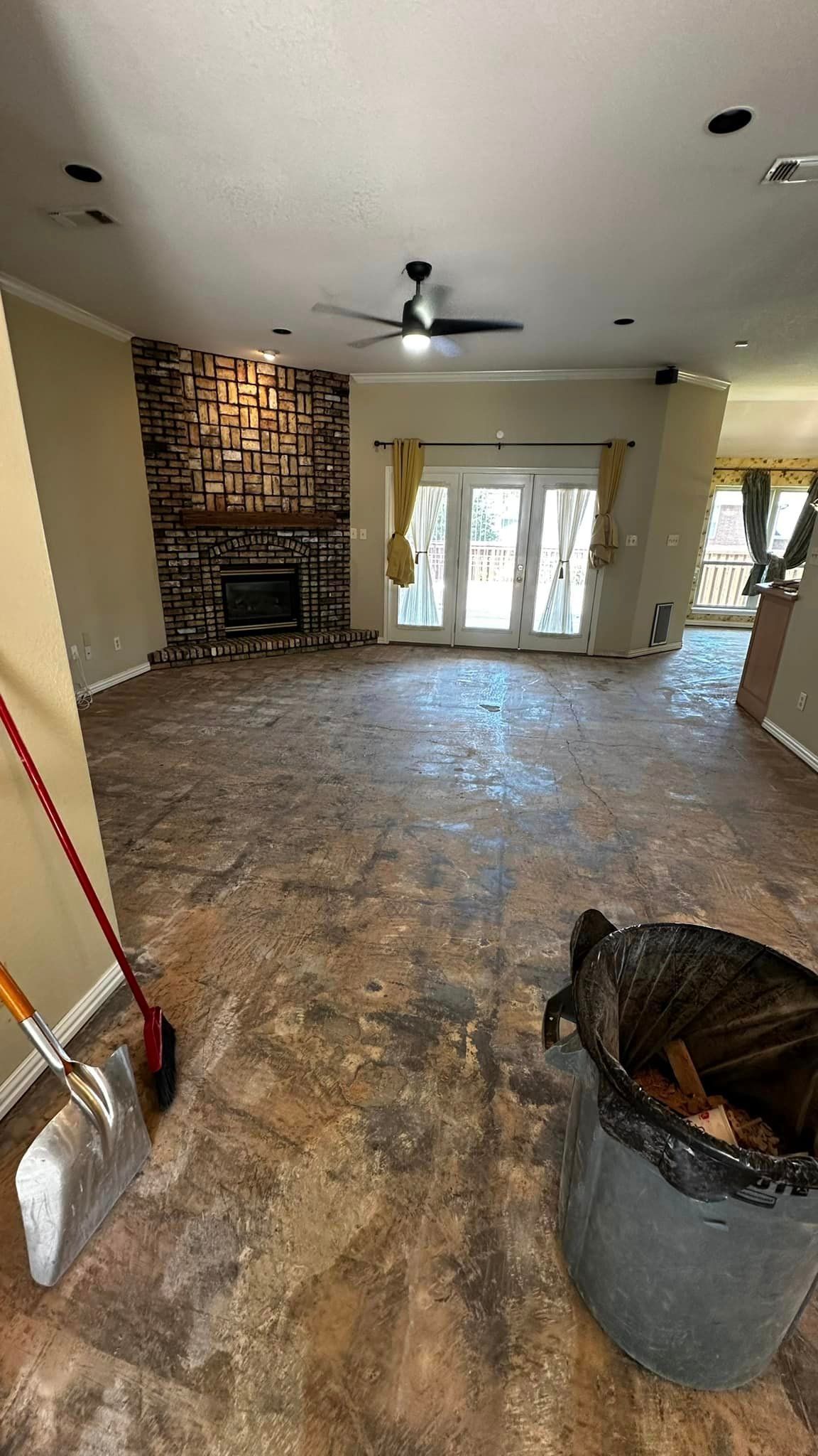 There is a trash can in the middle of the living room.