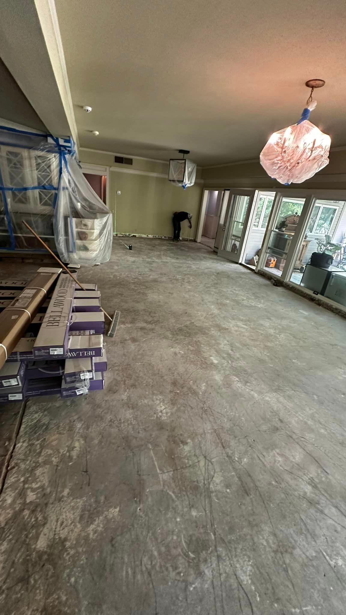 A large room with a lot of windows and a chandelier hanging from the ceiling.