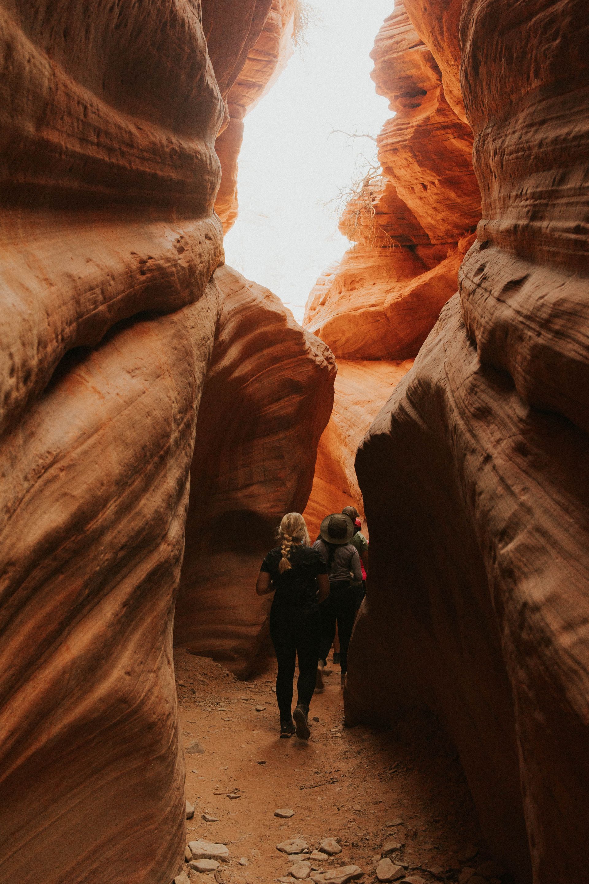 People walking through a narrown canyon