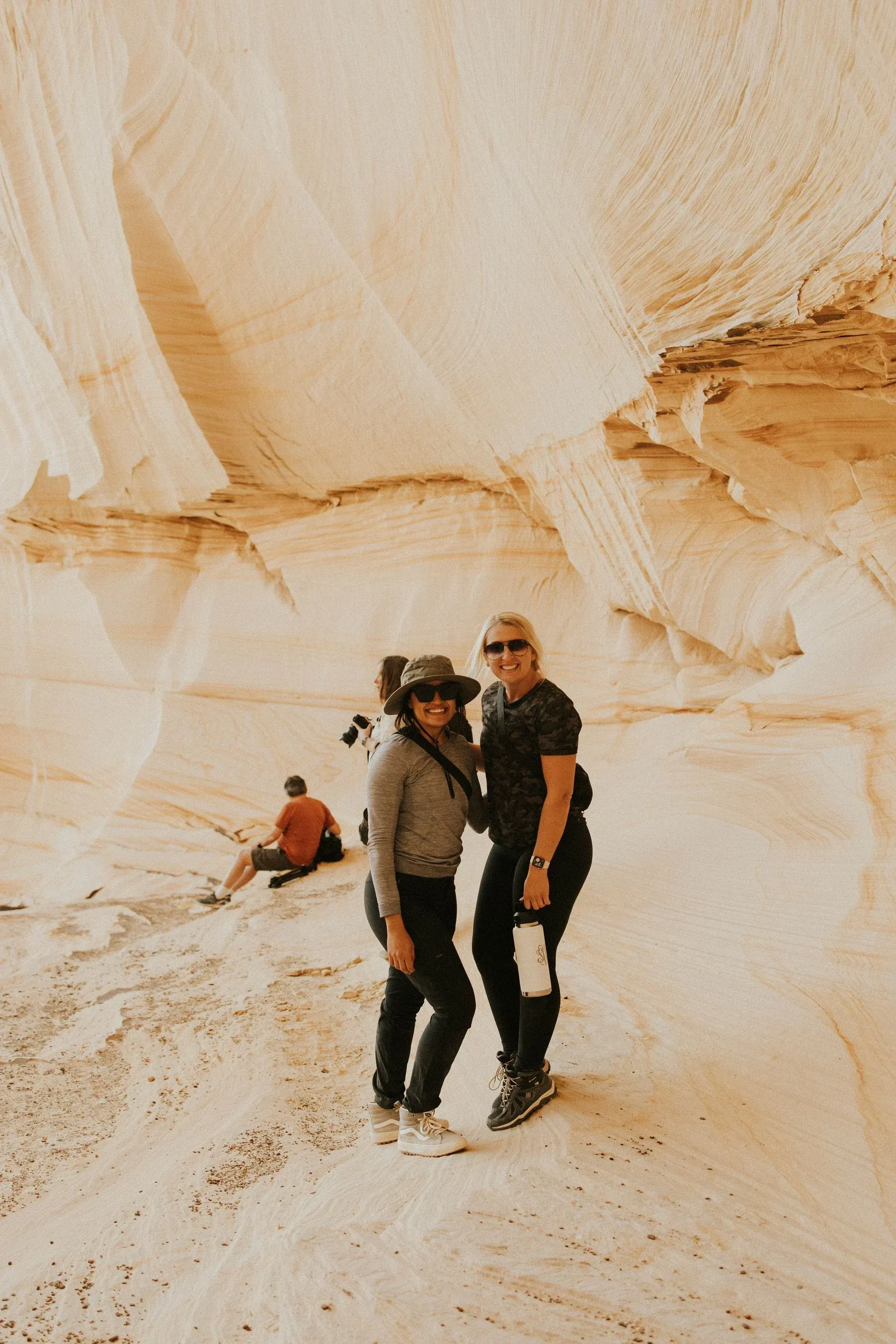 Two women are standing next to each other in the desert.