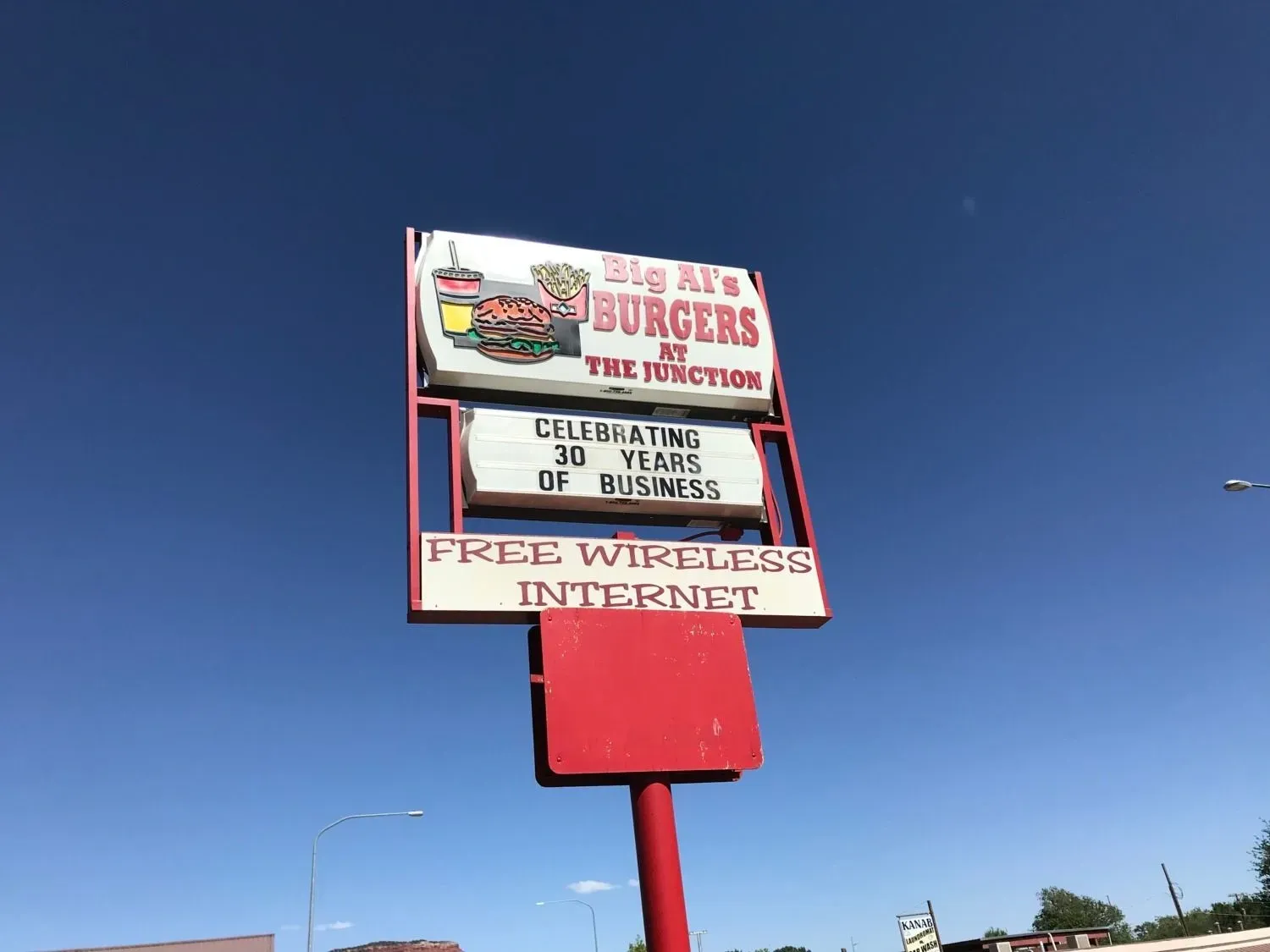 A red and white sign for big al 's burgers and the turkeys