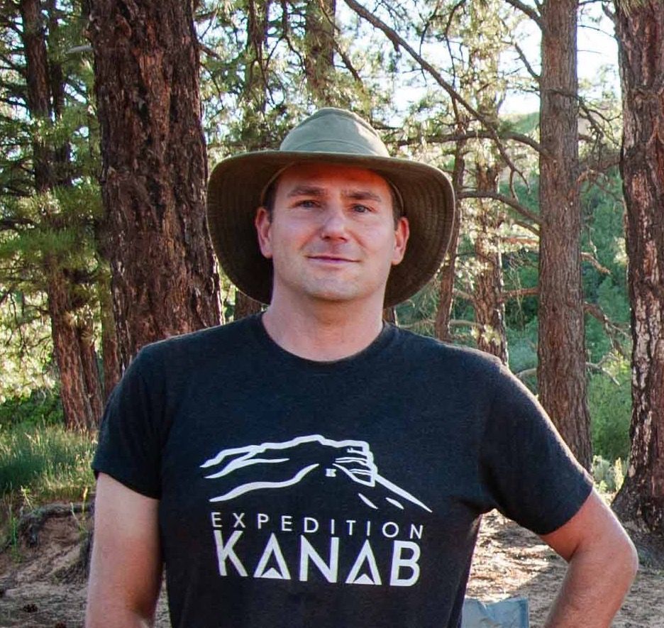 A man wearing a hat and a t-shirt that says expedition kanab