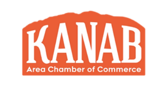 An orange and white kanab area chamber of commerce logo