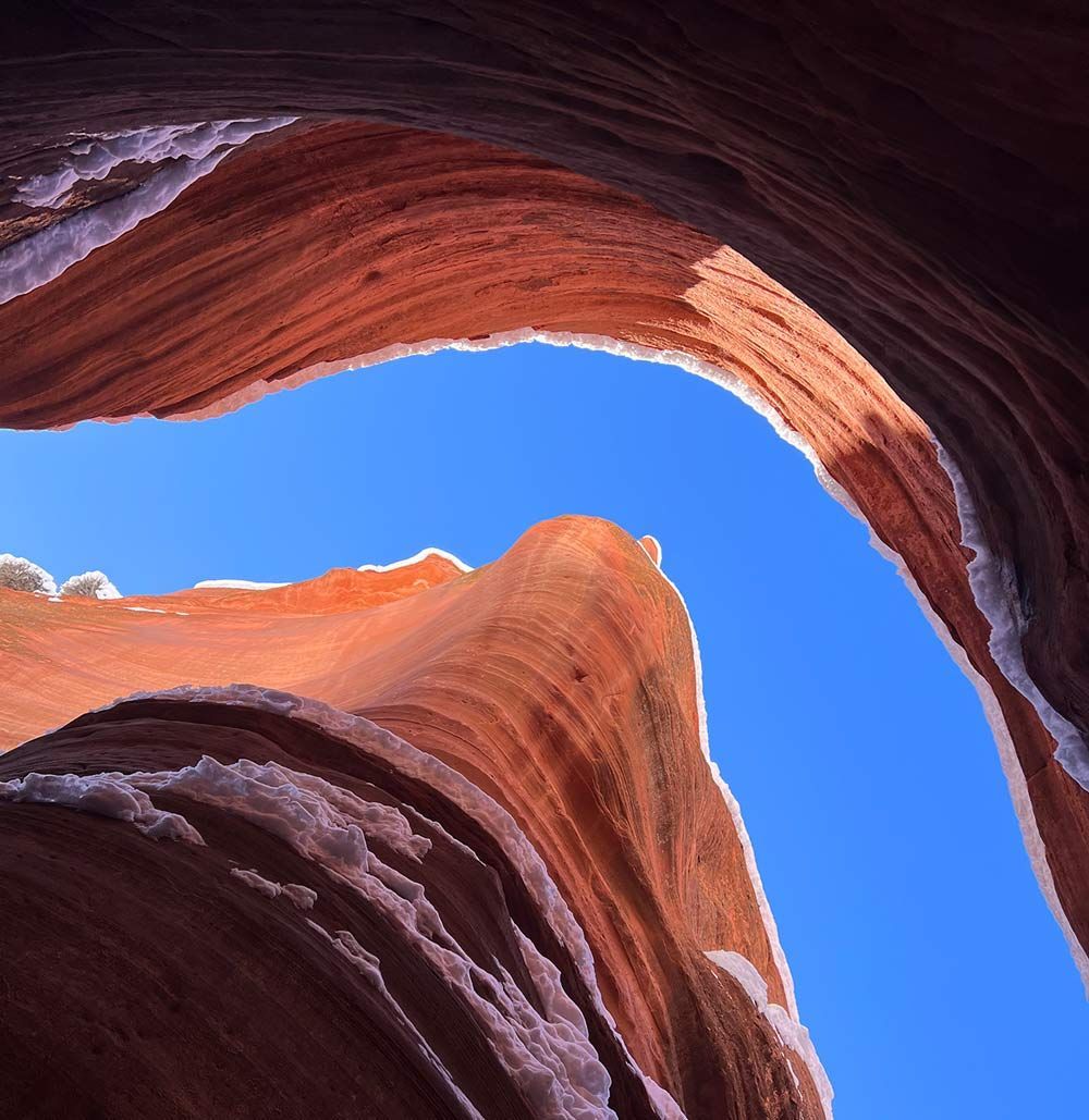 Looking up at a rock formation with a blue sky in the background