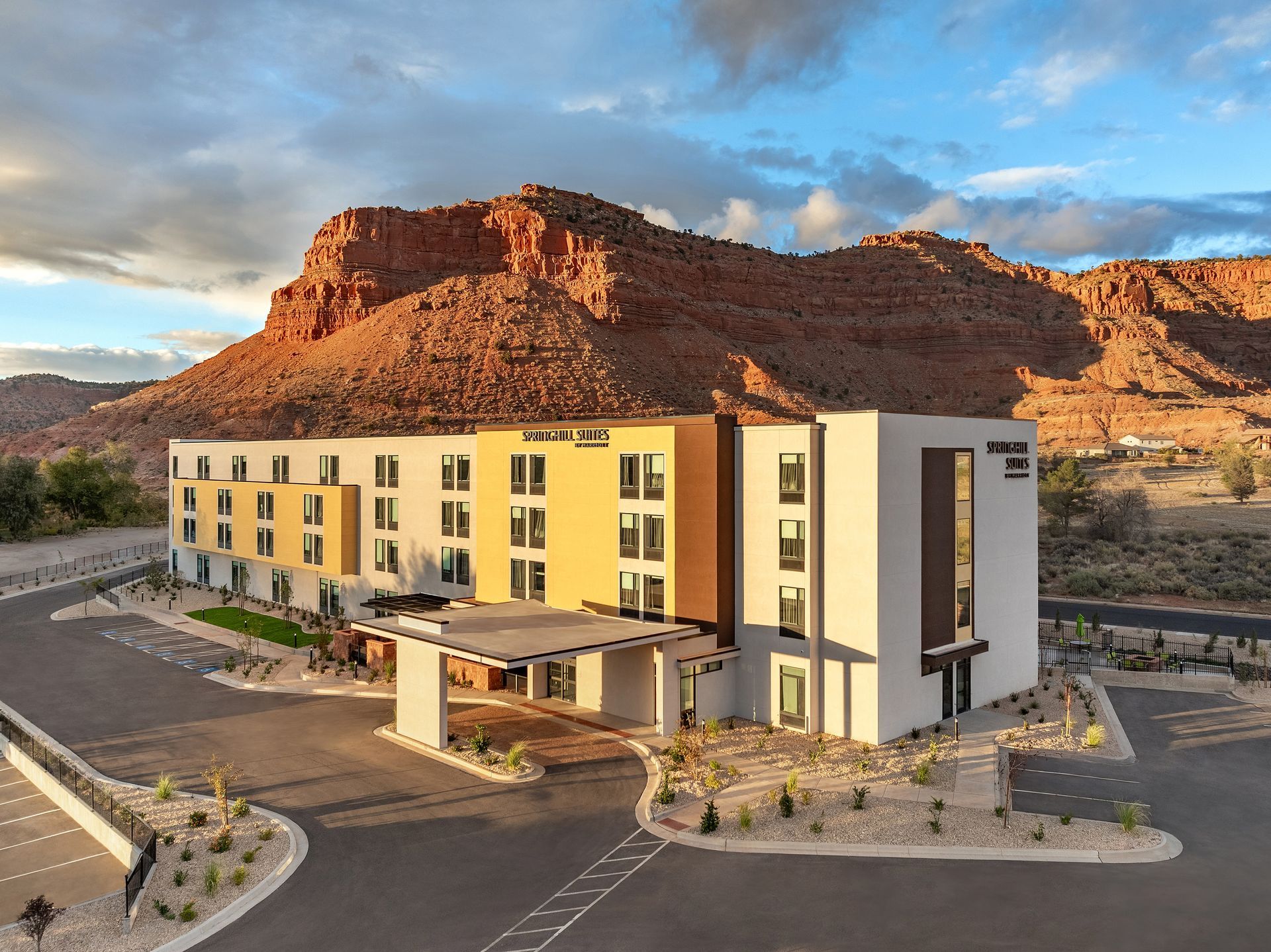 An aerial view of a hotel with a mountain in the background