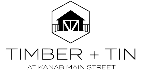 A black and white logo for timber + tin at kanab main street.