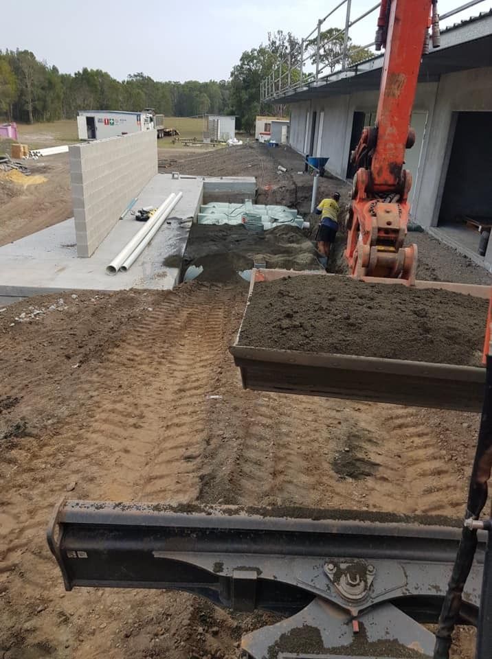 Orange Excavator Working on Construction Site