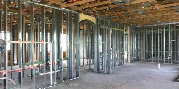 Interior construction of a building. Metal framing and exposed ceiling structure.