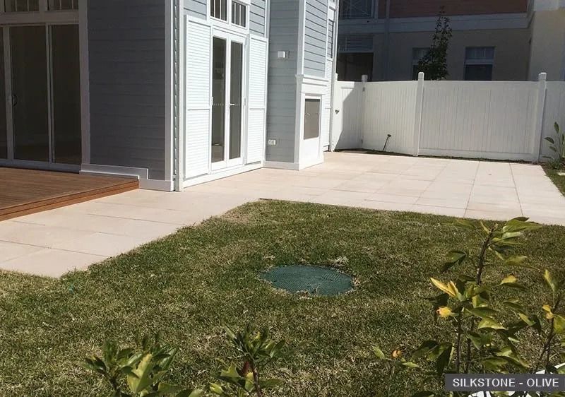 Backyard Patio With Grass, Tan Stone Pavers — Hunter Valley Bricks & Pavers in Scone, NSW