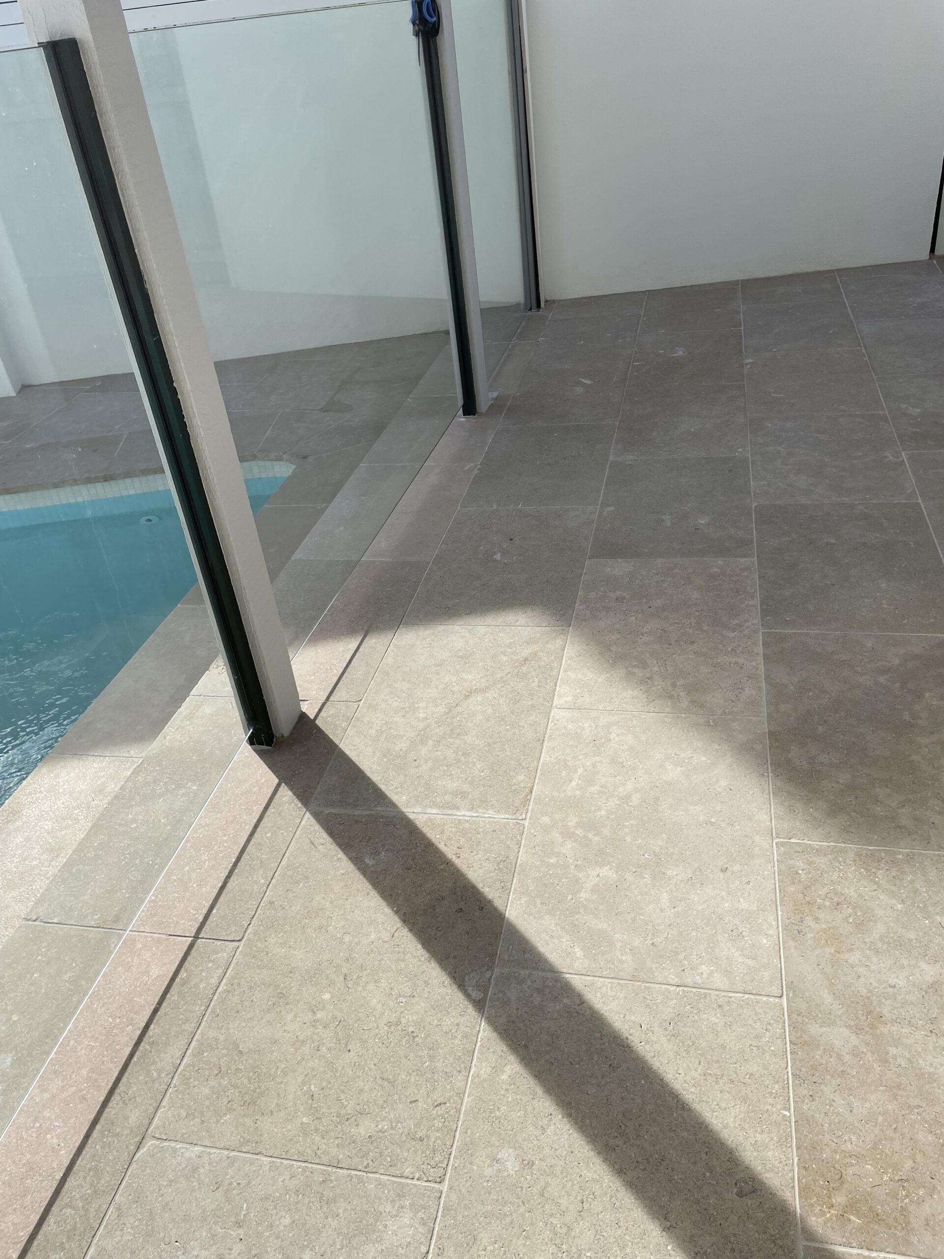 Poolside With Tiled Flooring; a Long Shadow Casts Across the Tiles From a Support Column — Hunter Valley Bricks & Pavers in Scone, NSW