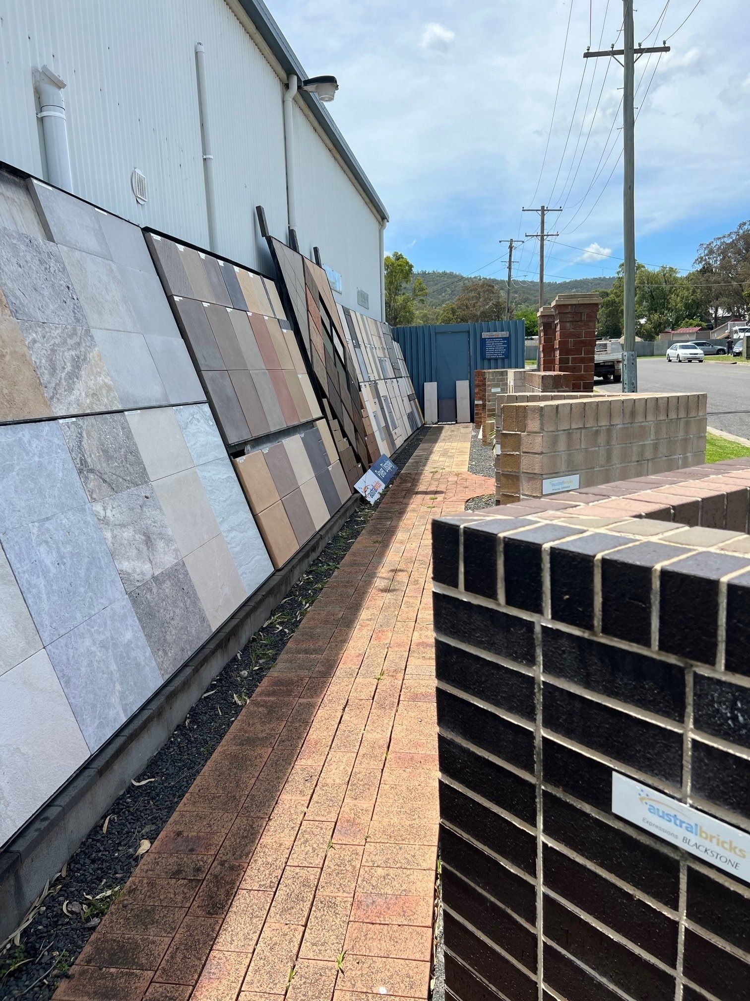 Display of Paving Stones and Brickwork Samples Outside a Building — Hunter Valley Bricks & Pavers in Scone, NSW