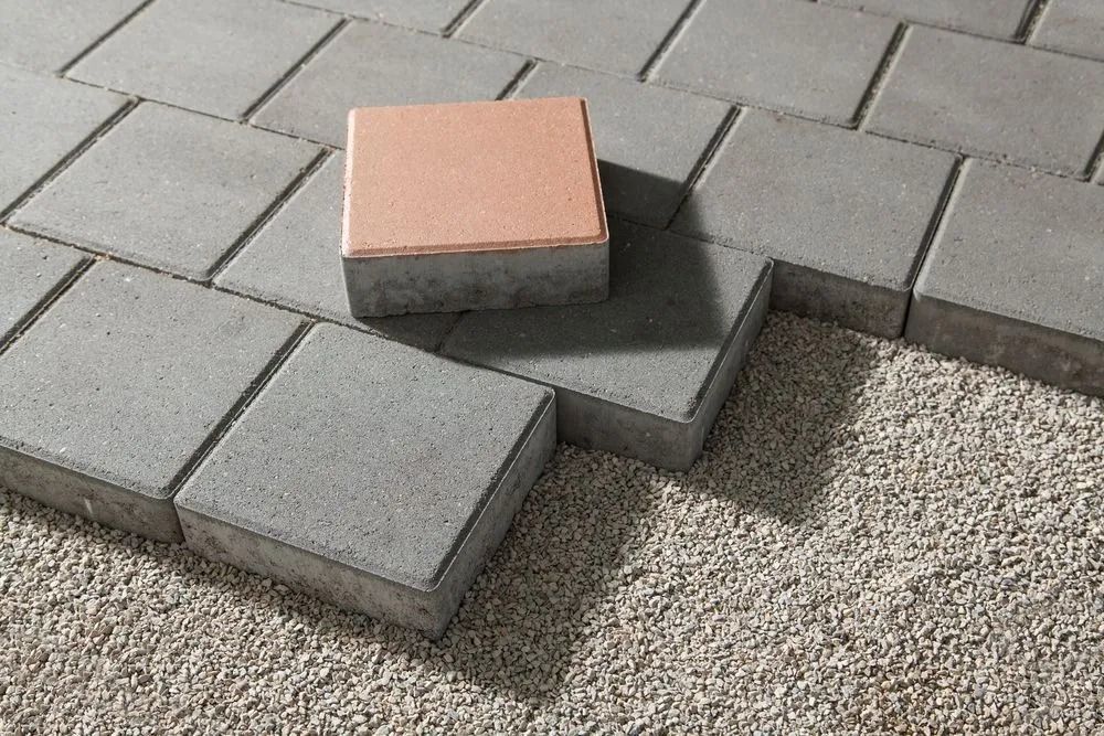 Close-up of Gray Paving Stones Being Laid — Hunter Valley Bricks & Pavers in Scone, NSW