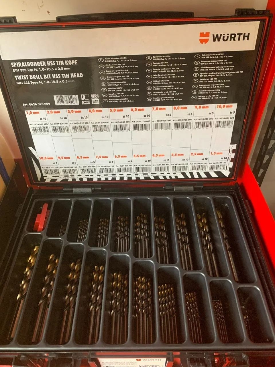 Open Red Toolbox Filled With Various Sized Gold-coloured Drill Bits — Hunter Valley Bricks & Pavers in Singleton, NSW