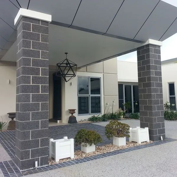 Entrance With Concrete Pillars, Gray Brick Accents, White Planters With Green Plants — Hunter Valley Bricks & Pavers in Scone, NSW