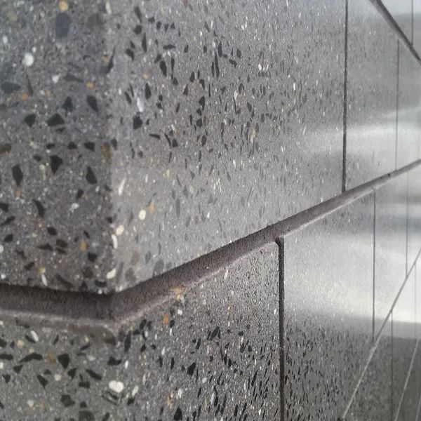 Close-up of a Dark Grey Concrete Wall With Exposed Aggregated — Hunter Valley Bricks & Pavers in Scone, NSW