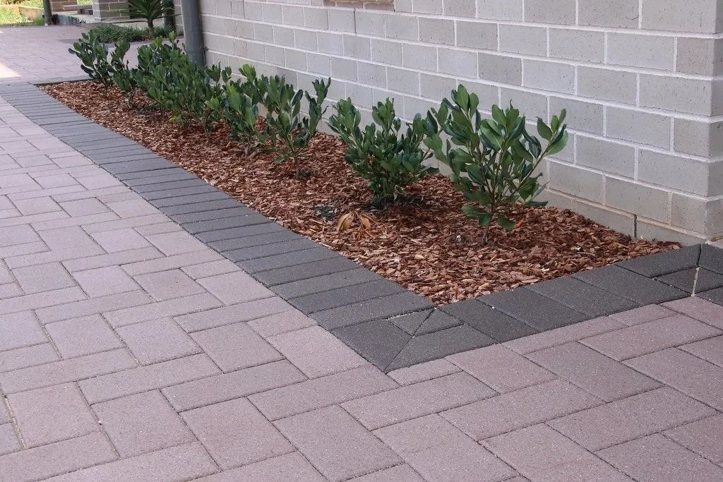 Brick Paving With a Raised Garden Bed Against a Brick Wall — Hunter Valley Bricks & Pavers in Scone, NSW
