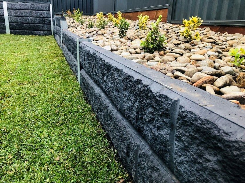Gray Retaining Wall With Rocky Texture — Hunter Valley Bricks & Pavers in Scone, NSW