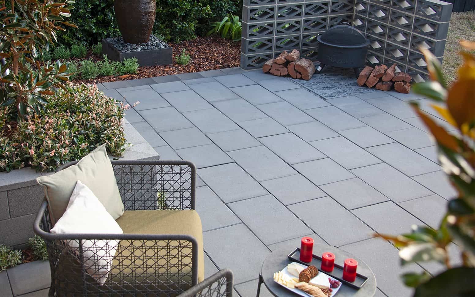 Patio With Gray Pavers, Seating, and a Small Table With Food — Hunter Valley Bricks & Pavers in Scone, Nsw