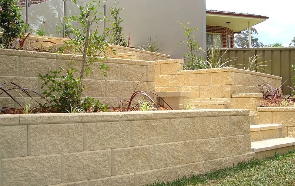 Beige Block Retaining Walls Terraced With Plants — Hunter Valley Bricks & Pavers in Scone, NSW