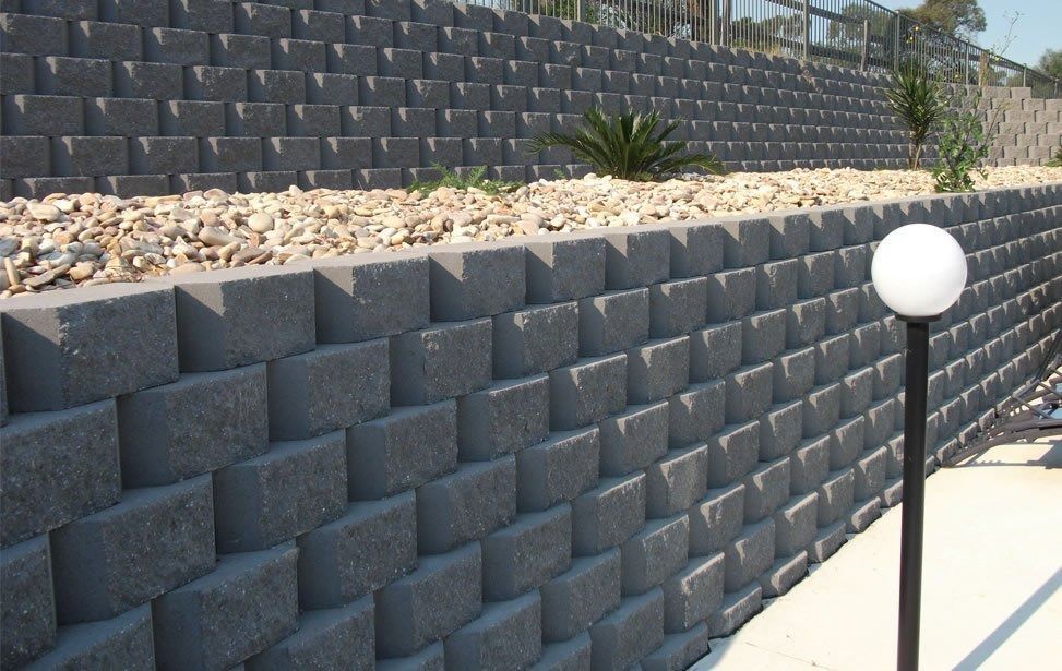 Dark Gray Retaining Wall Built of Angled Blocks — Hunter Valley Bricks & Pavers in Scone, NSW