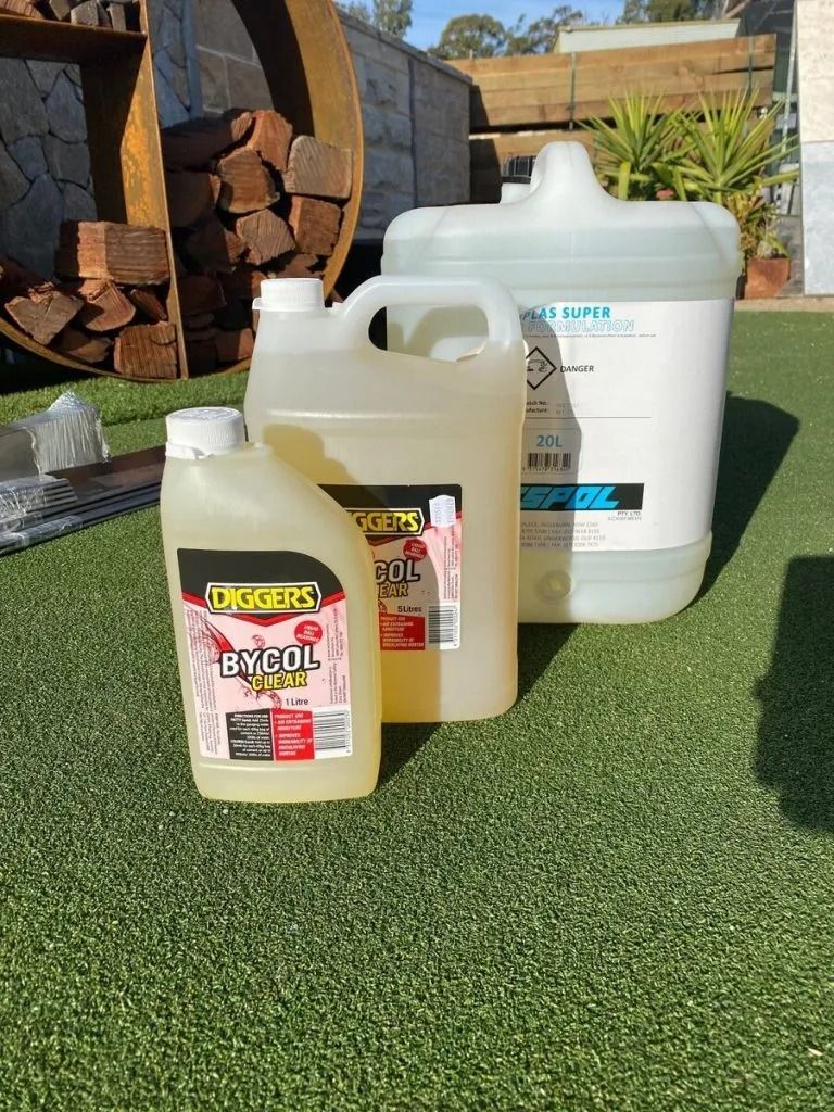Three Chemical Containers on Green Artificial Grass — Hunter Valley Bricks & Pavers in Scone, NSW