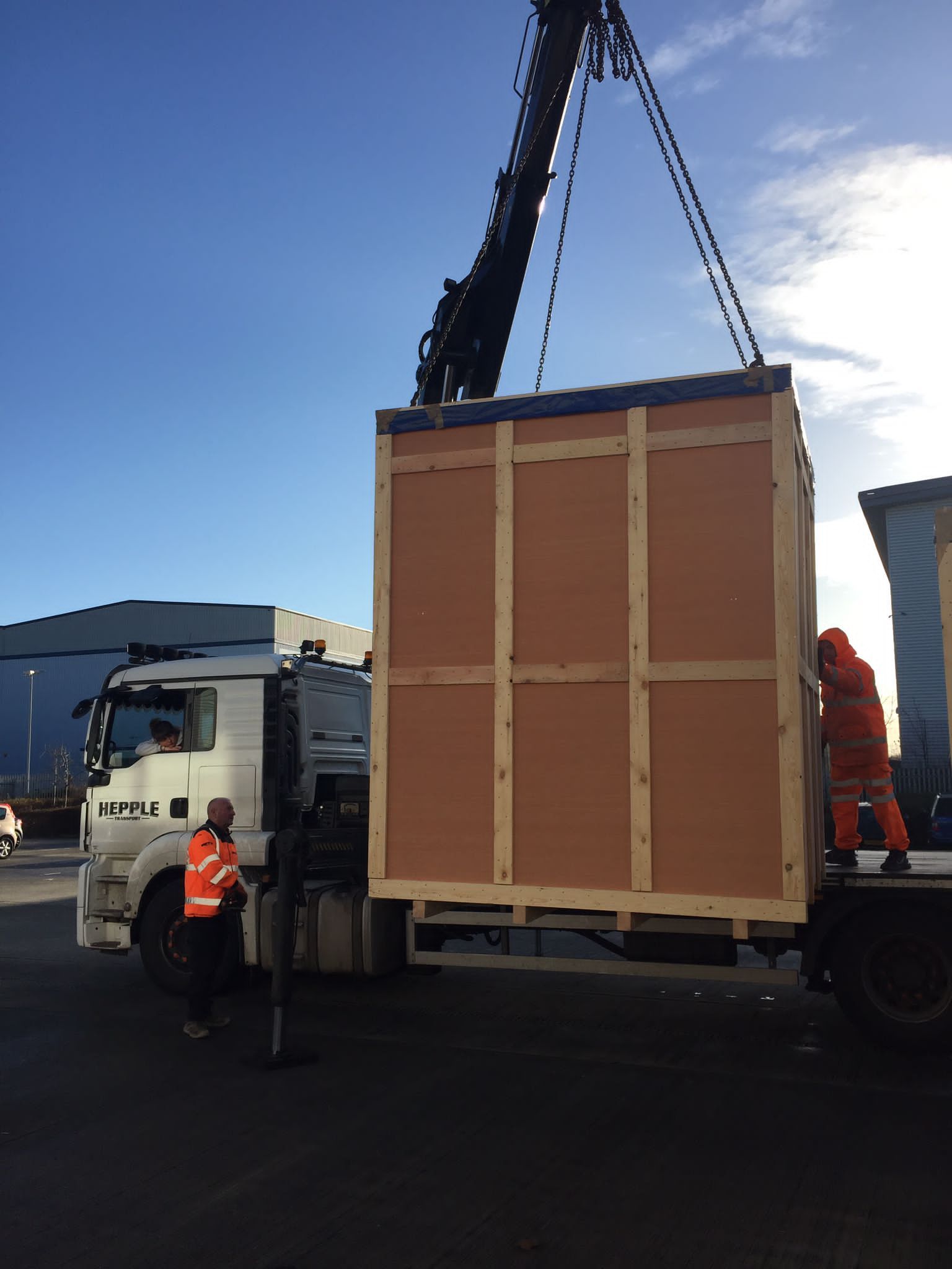 Control panel system being delivered to site in a crate off the back of a lorry