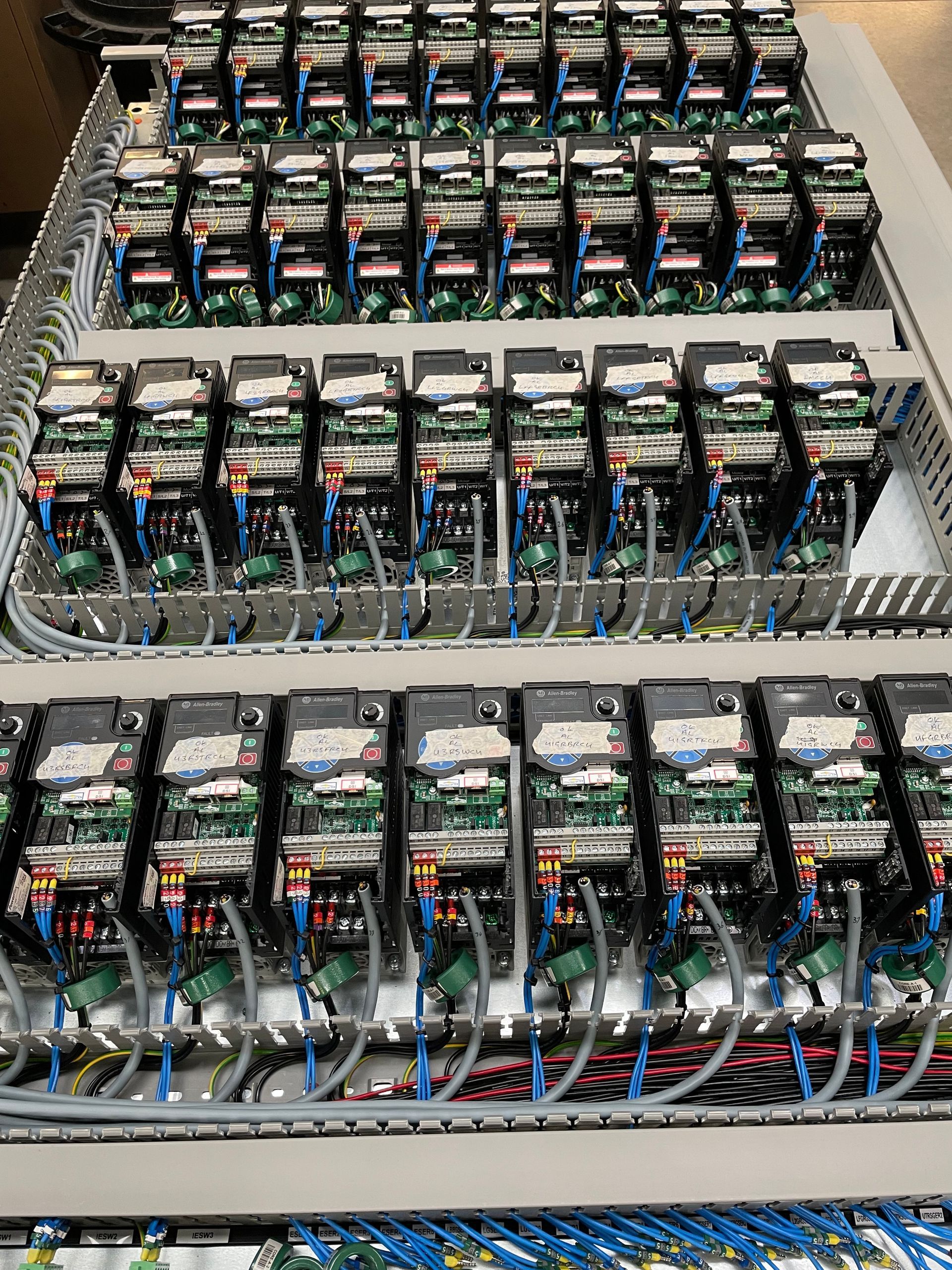 Allen Bradley variable speed drives that are partially wired on a backplate, ready for final assembly into a Rittal enclosure.