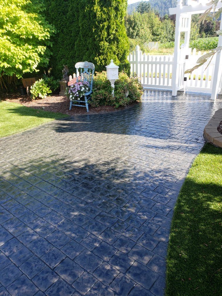 A patio with a chair and a mailbox in the backyard.