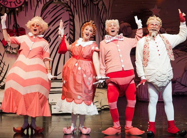 4 actors onstage wearing colorful costumes