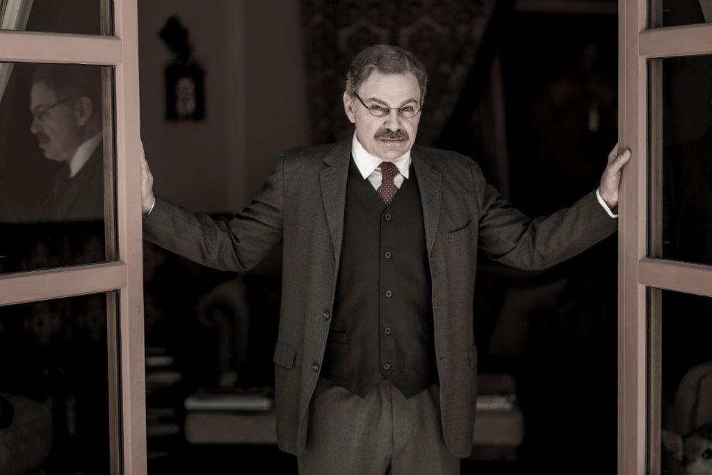 As President T. Roosevelt in standing in open doorway