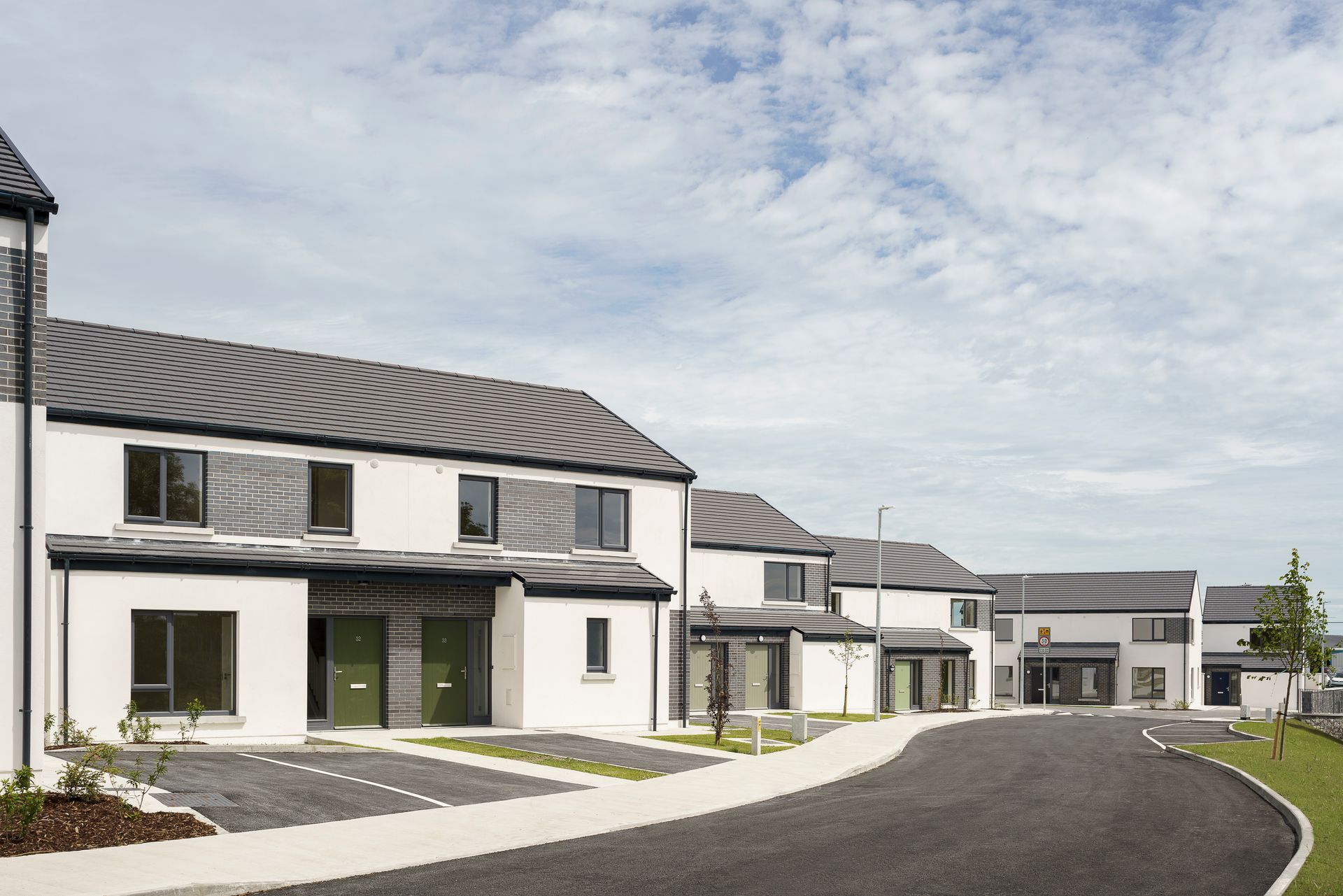 A row of houses are lined up next to each other on a sunny day.