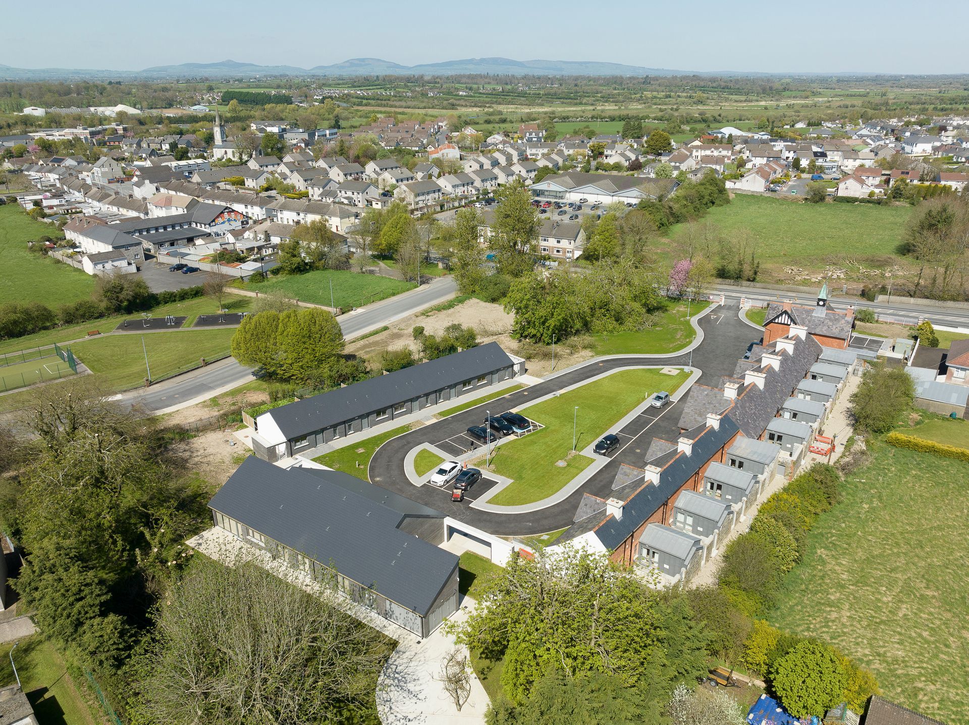 An aerial view of a residential area with a lot of houses and trees.