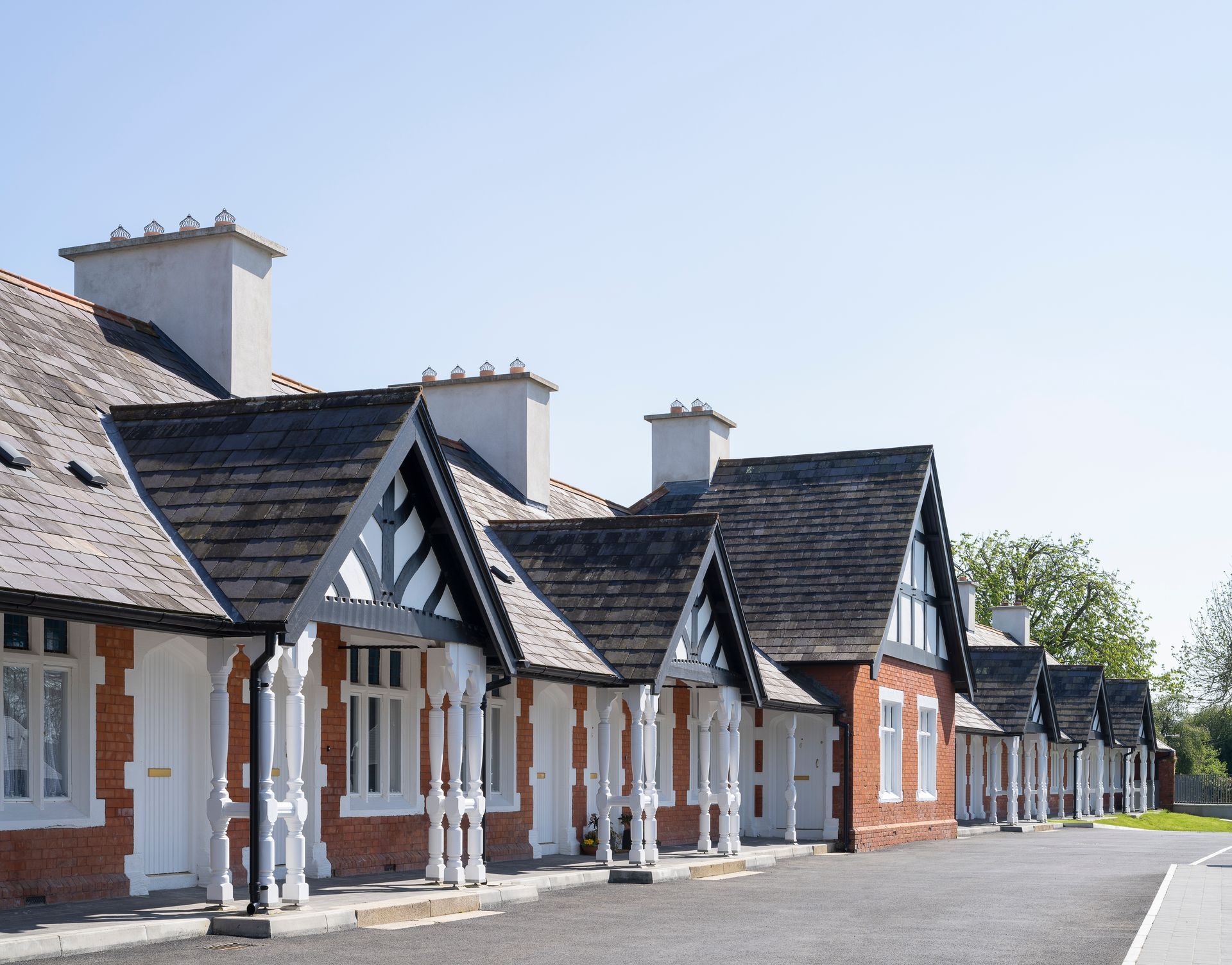A row of houses with a blue sky in the background