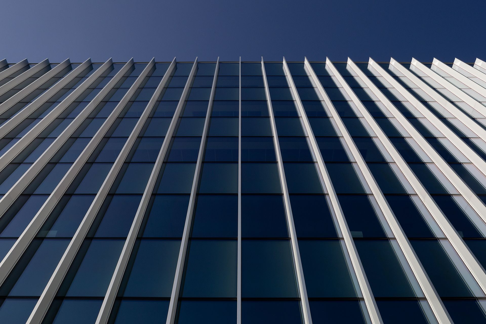Looking up at a tall building with a blue sky in the background