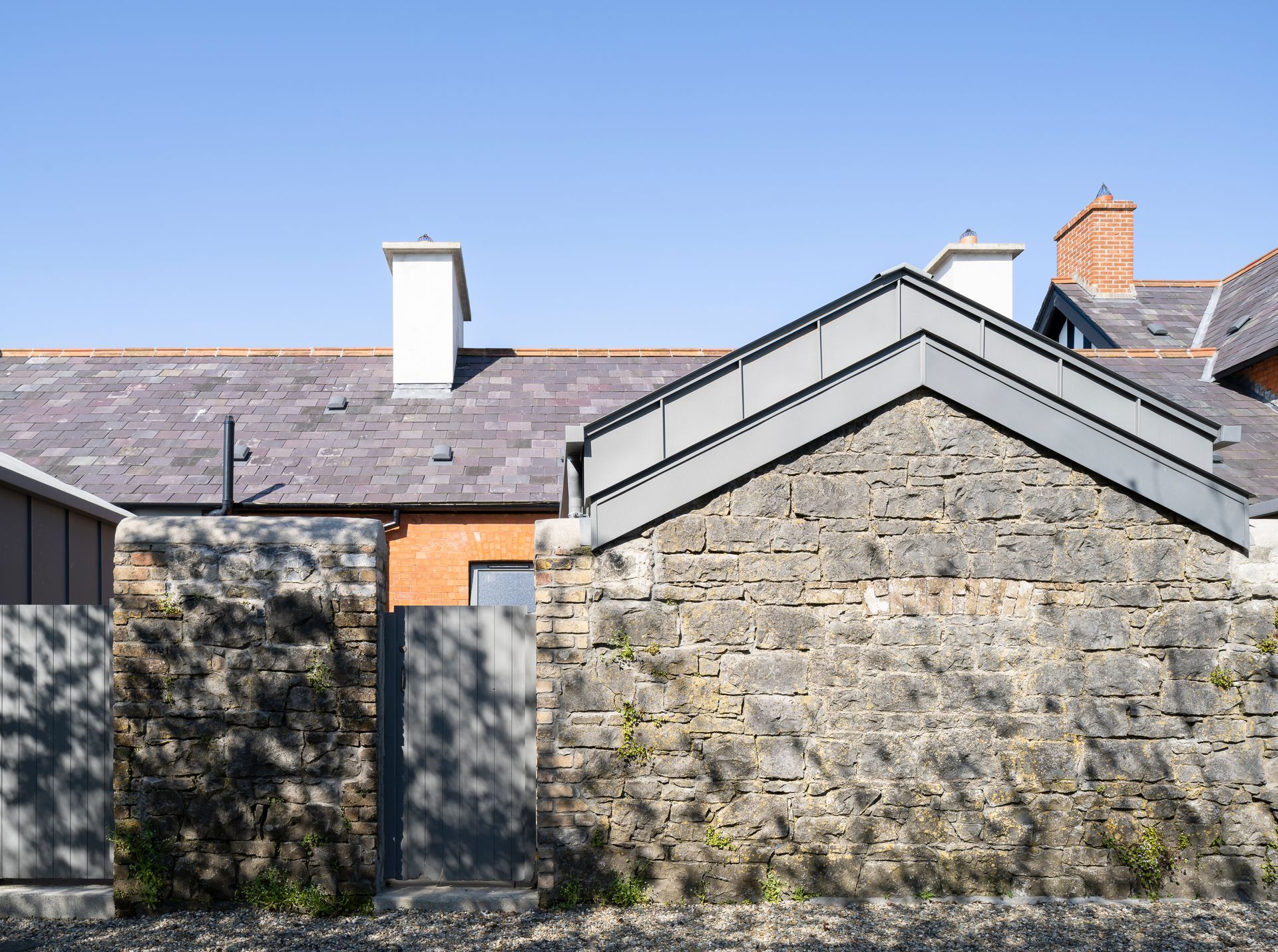 A brick building with a roof that has a chimney on it