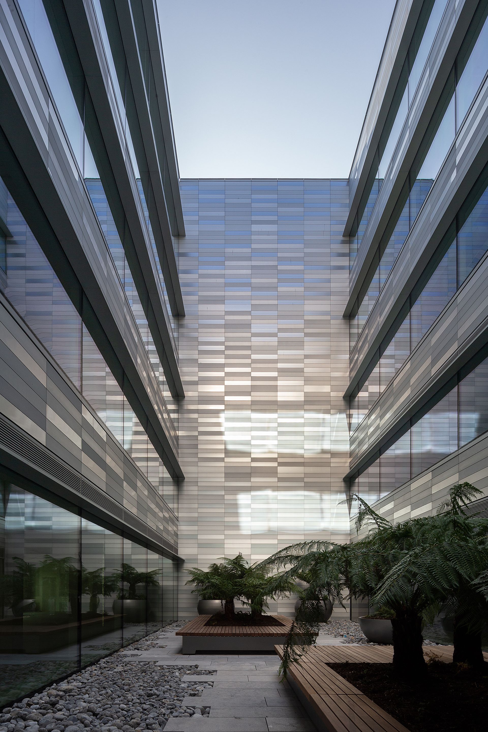 A building with a lot of windows and a courtyard in the middle of it.