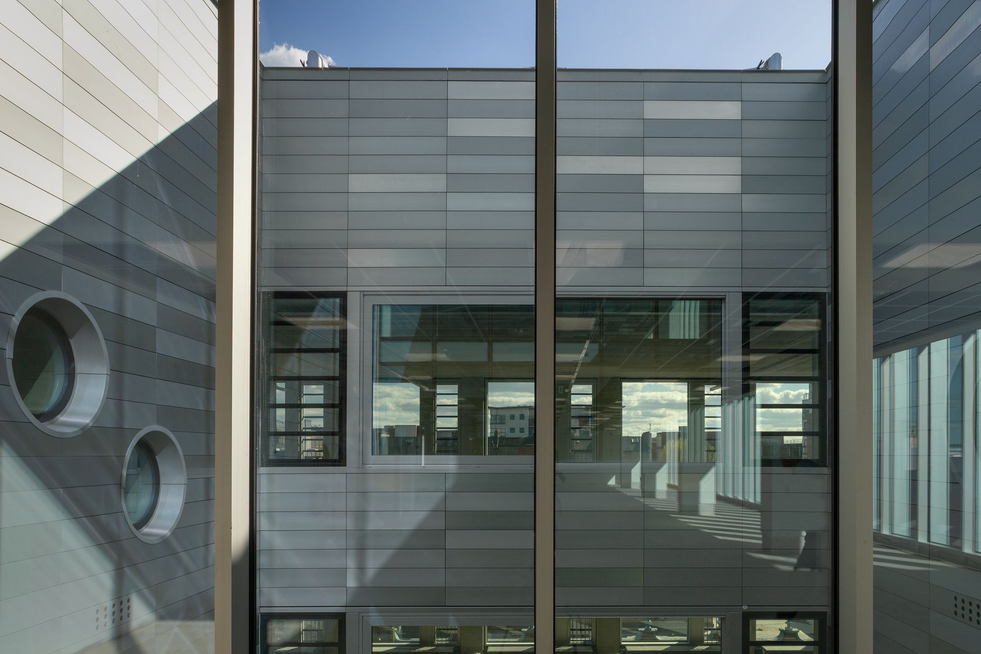 A building with a lot of windows and a blue sky in the background