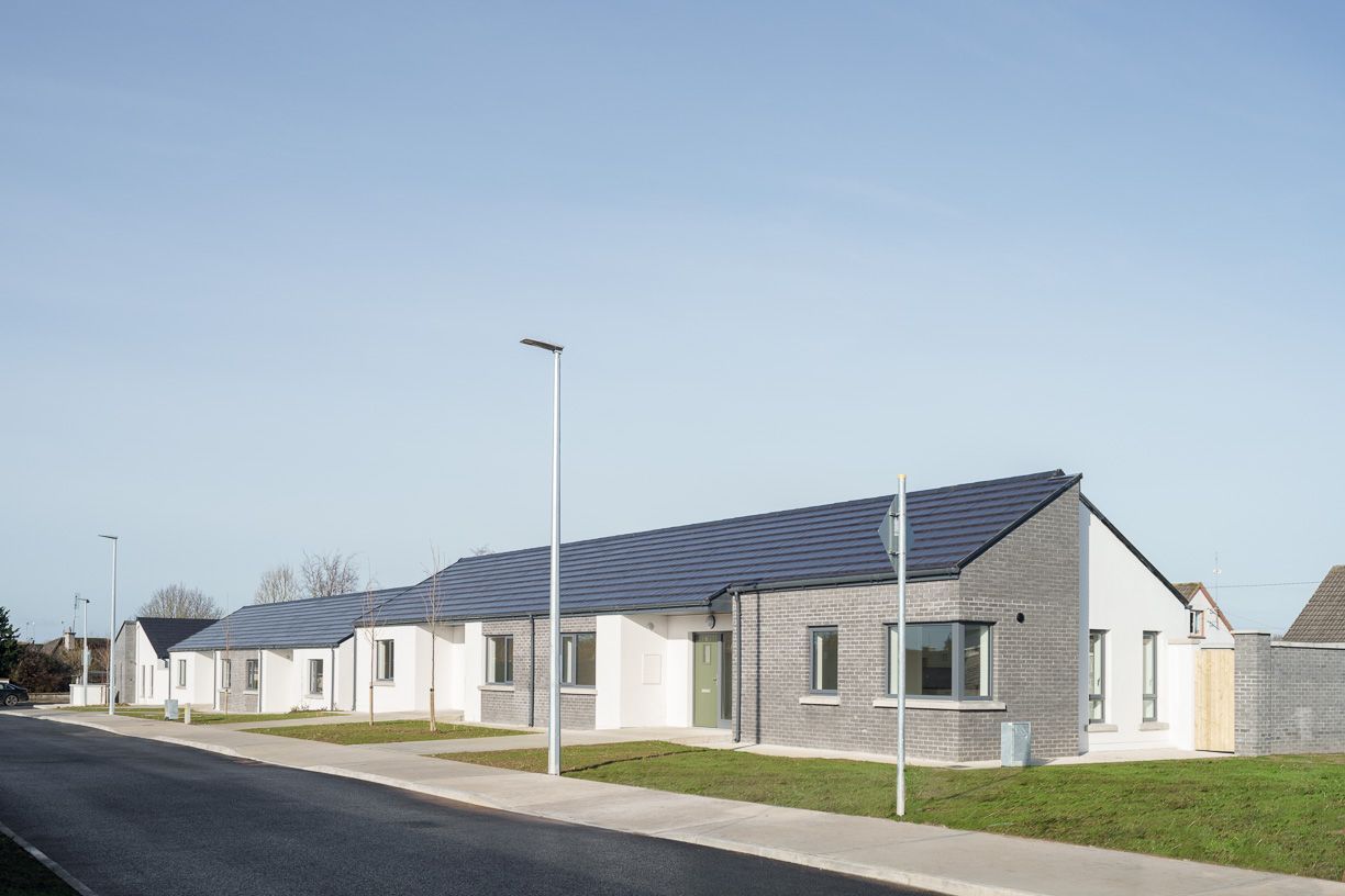 A row of houses with solar panels on the roofs