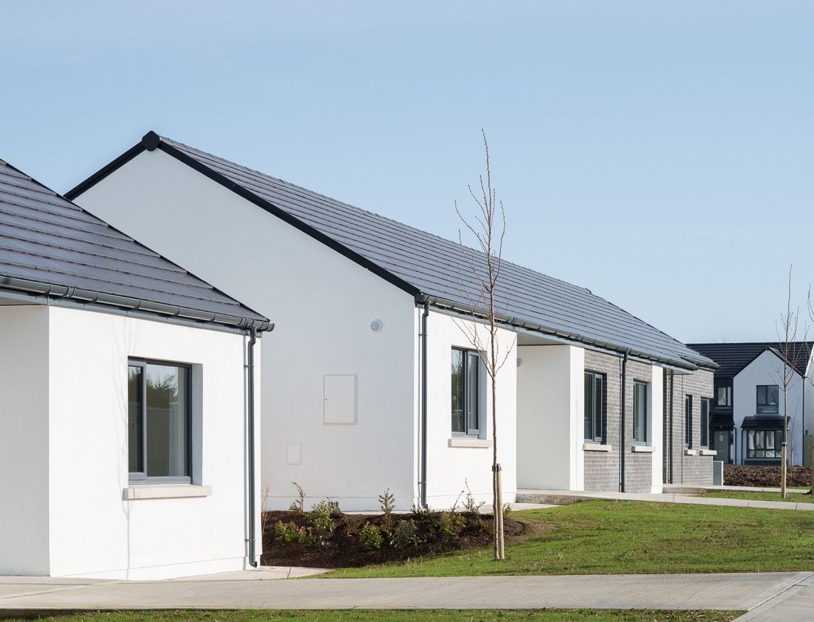 A row of white houses with black roofs
