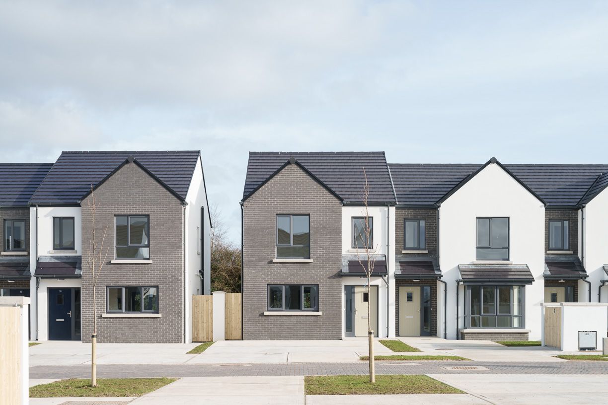 A row of houses with black roofs in a residential area.
