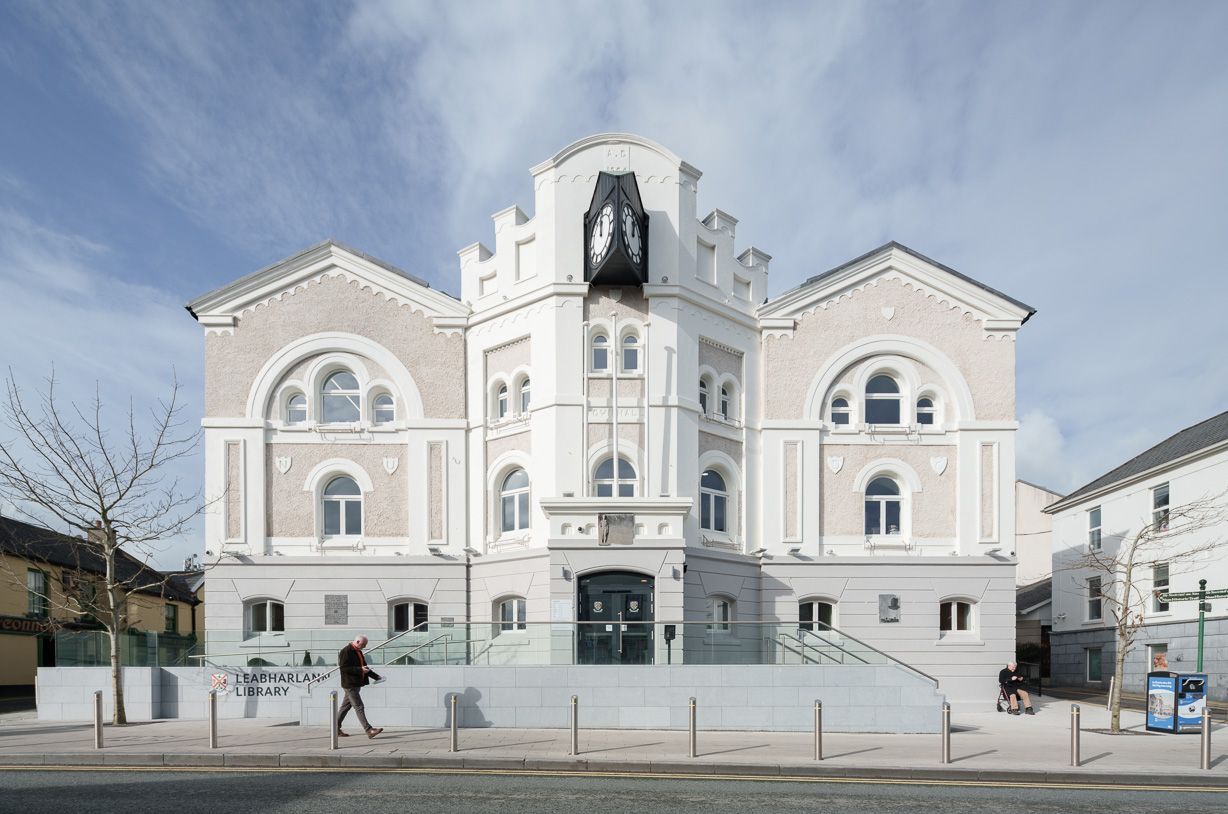 A large white building with a clock tower on top of it.