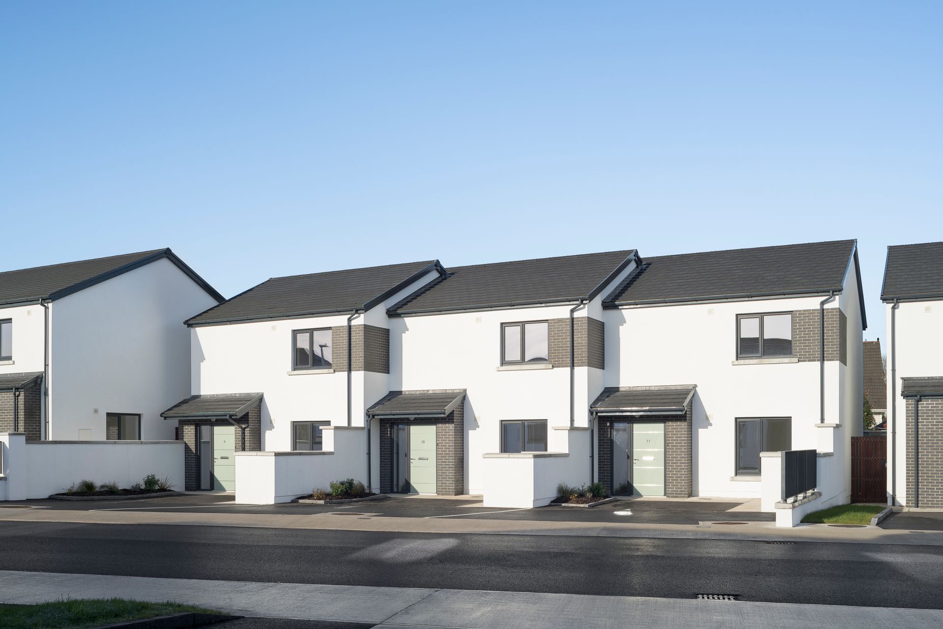 A row of white houses with black roofs