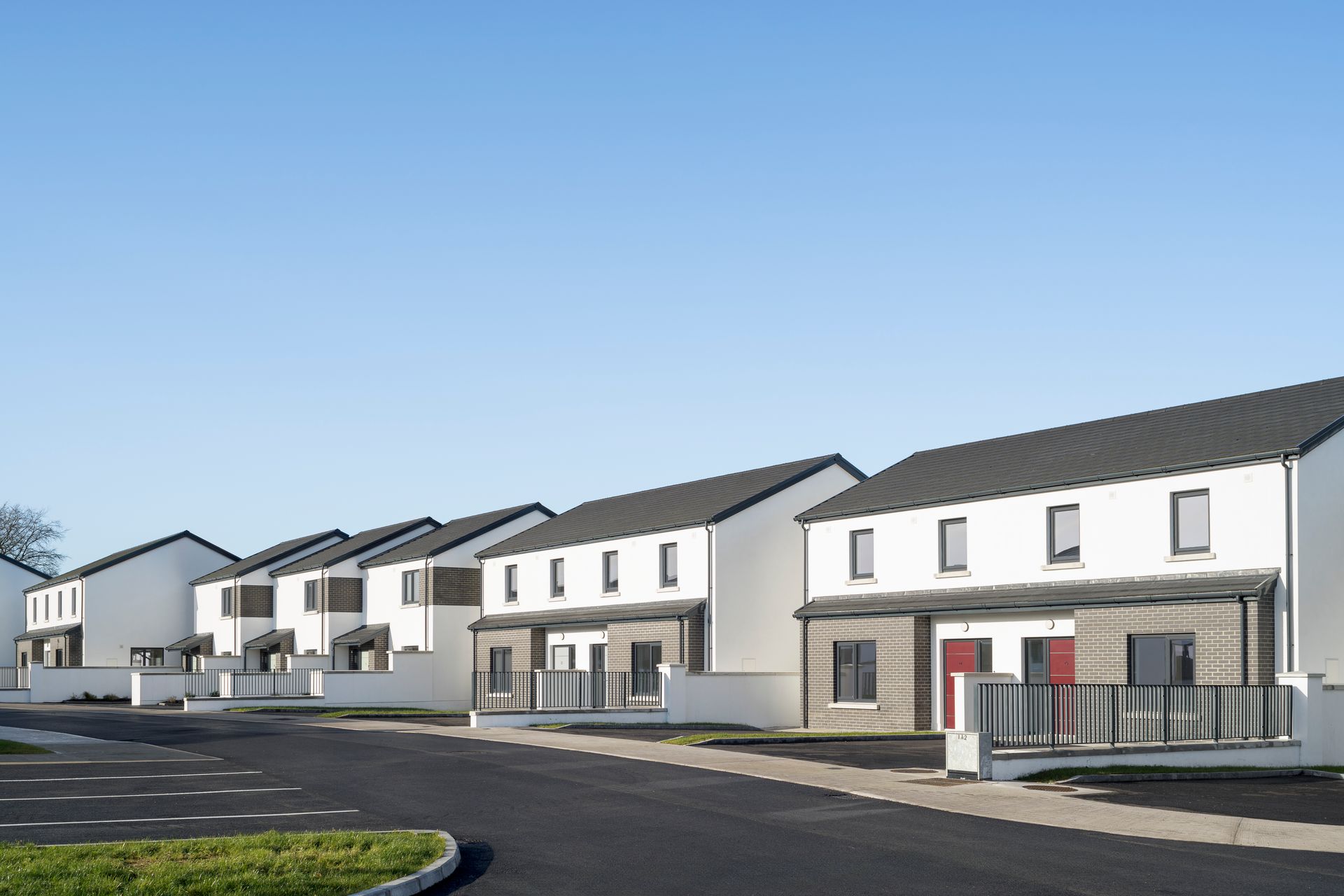 A row of houses with a blue sky in the background