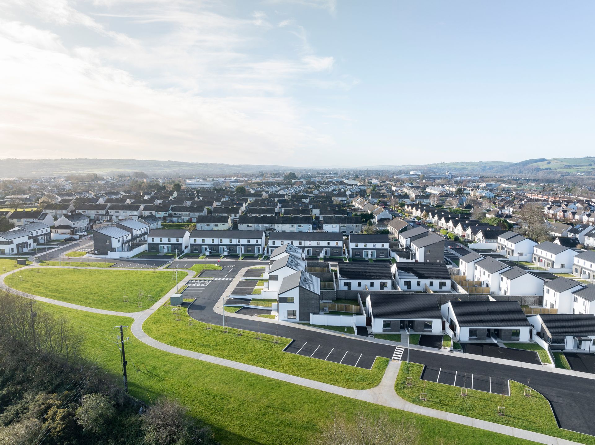 An aerial view of a residential area with lots of houses and parking spaces.