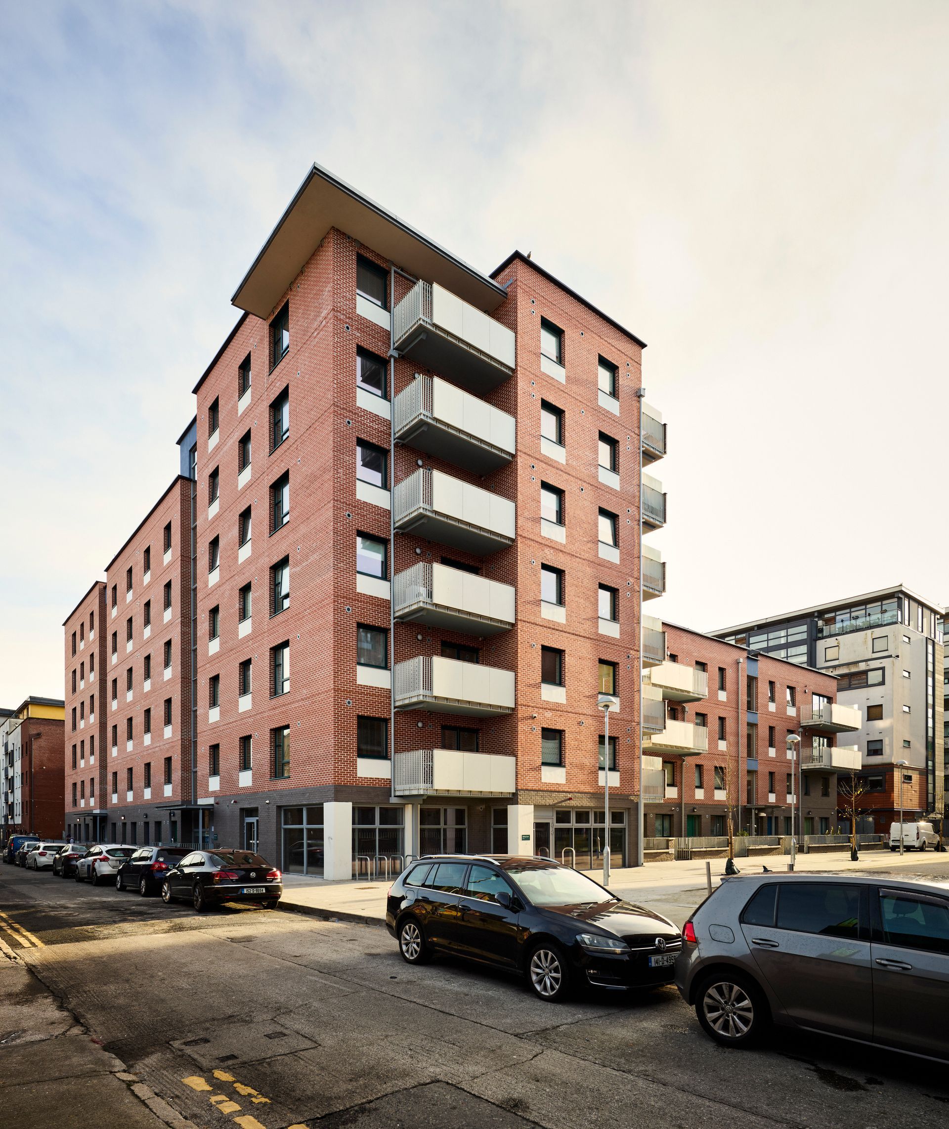 A brick building with cars parked in front of it