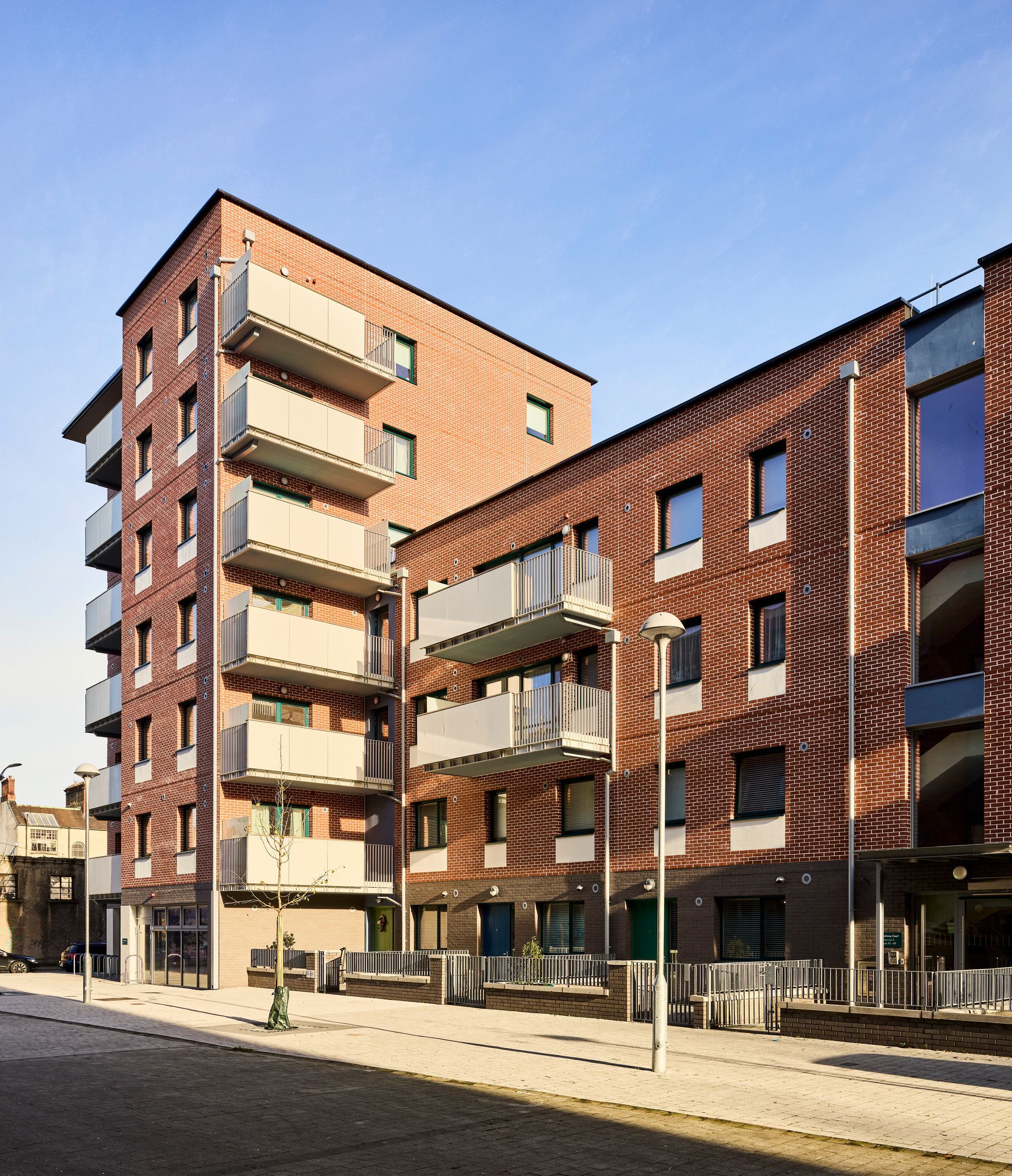 A brick building with a lot of balconies and windows